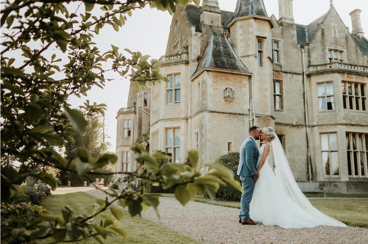 Couple Kissing Outside of Orchardleigh House Wedding Venue