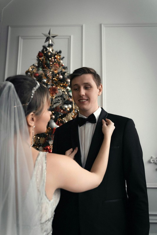 Bride Adjusting Grooms Jacket On Their Wedding Day