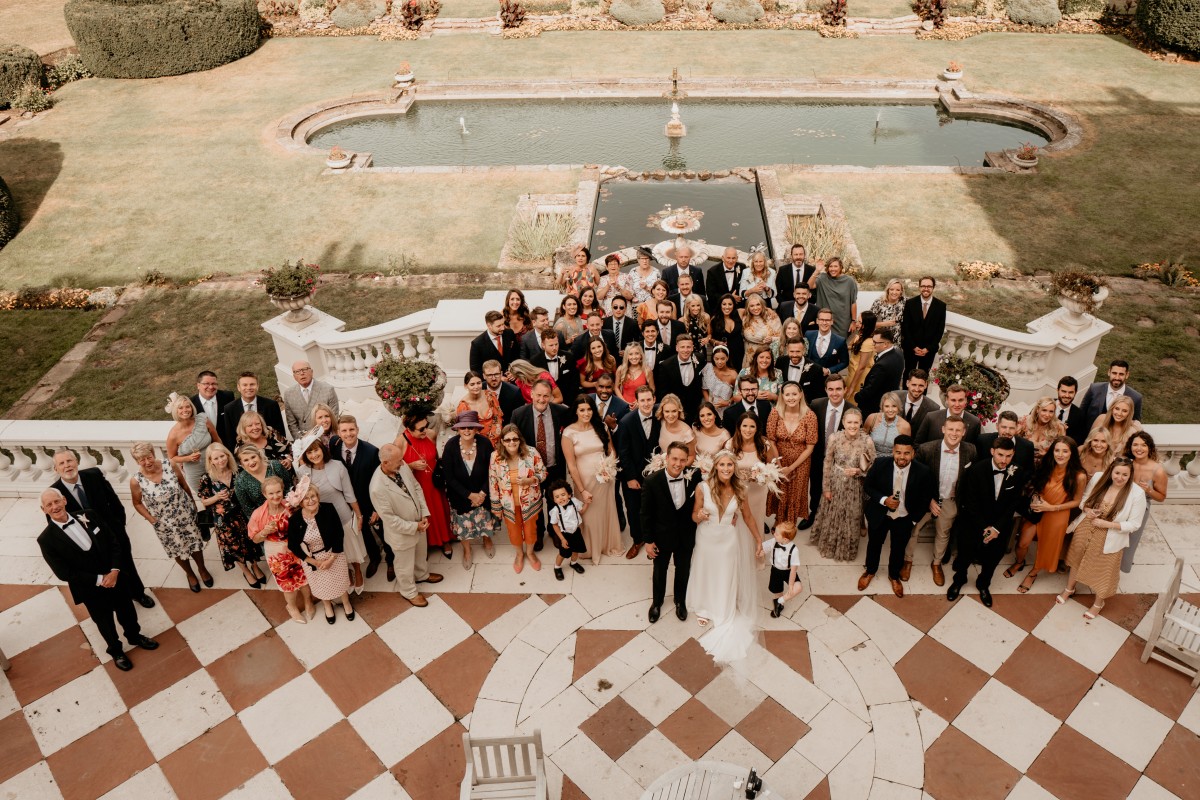 A wedding group photo by the balustrades at Swinfen Hall Wedding Venue